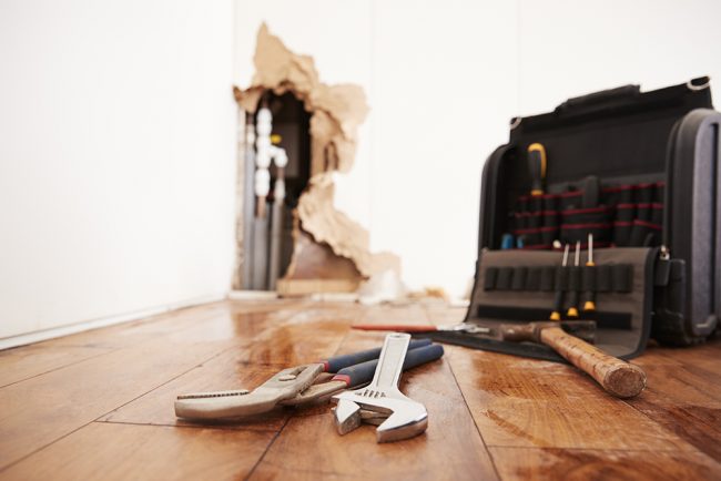 Tools and toolbox lying on flood damaged floor tools lying on a damaged floor