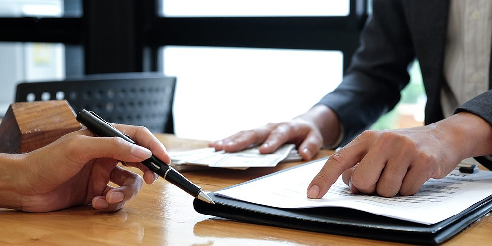 close up of signing paperwork for new home