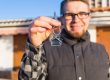 man holding key to new home