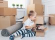 toddler on floor with moving boxes