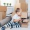 toddler on floor with moving boxes