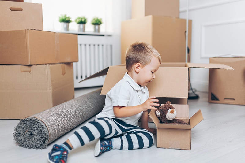 toddler on floor with moving boxes
