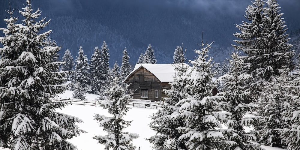 Fairy winter landscape in the Carpathian Mountains. Snow covered small mountain village.